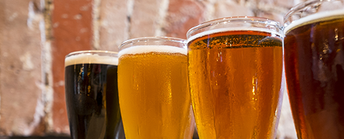 Close up of beers against a brick wall